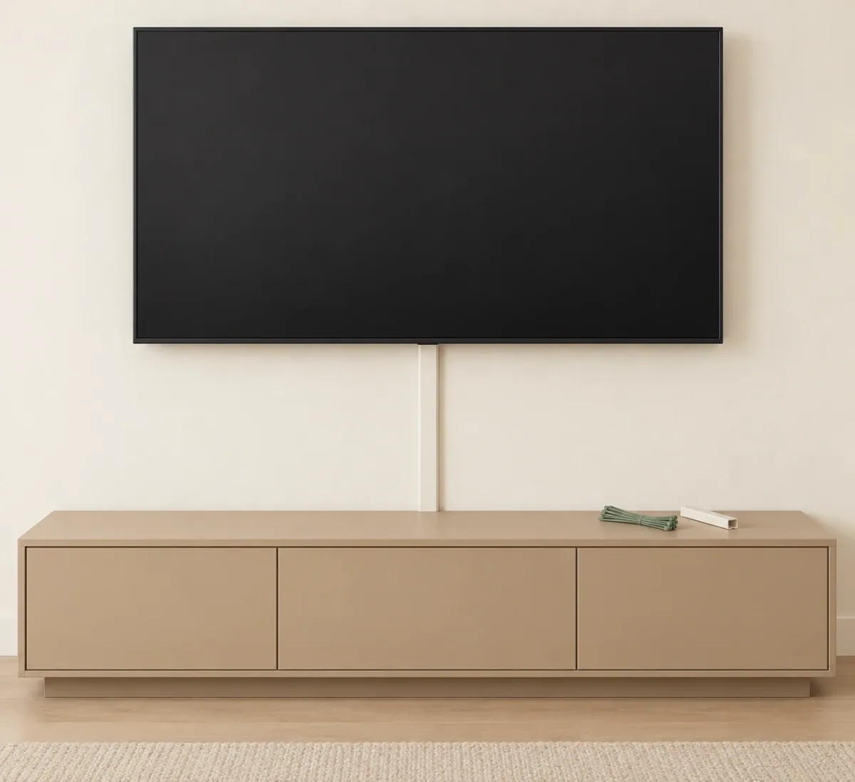 Illustration of a wall-mounted TV with one cable cover running down to a media console.